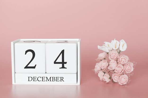 24 grudnia. Dzień 24 miesiąca. Kalendarzowy sześcian na nowożytnym różowym tle, pojęciu biznes i ważnym wydarzeniu.