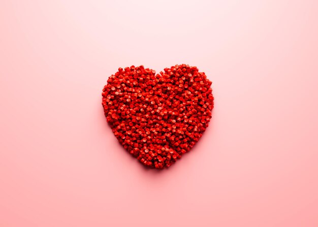 Zdjęcie 3d unikalny symbol kształtu serca wykonany z czerwonych plastikowych polimerów na miękkim różowym tle ilustracja 3d