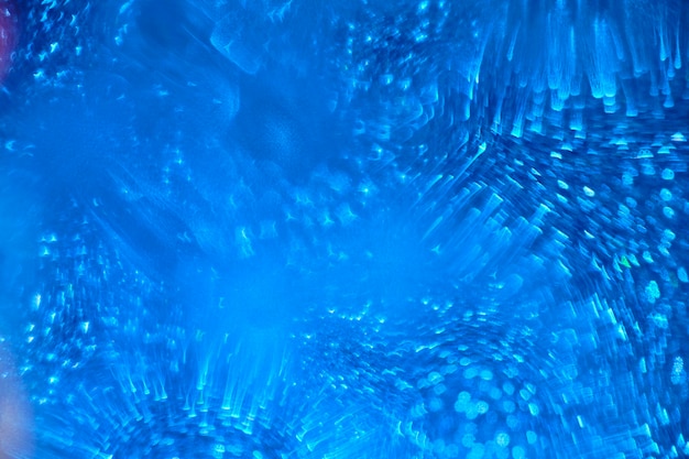 Abstrakcjonistyczny błękitny tło z niewyraźnymi błyszczącymi kształtami