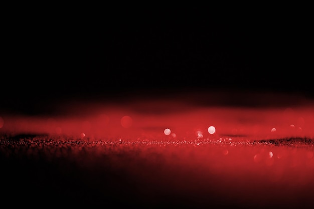 abstrakcyjny błyszczący czerwony brokat na ciemnym tle
