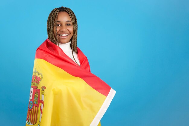 Afrykańska kobieta owinięta hiszpańską flagą narodową