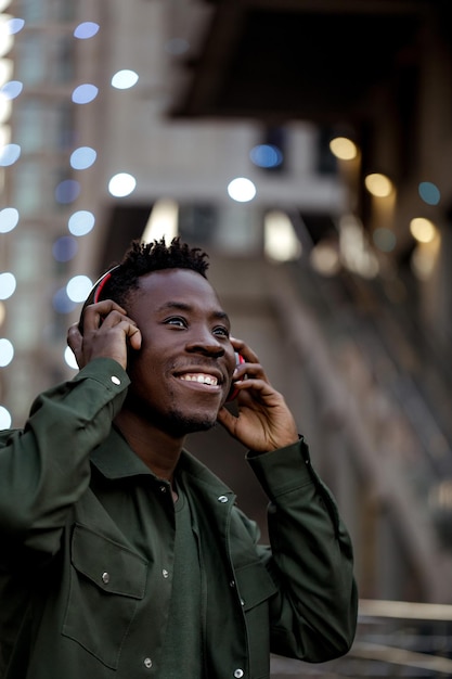 Afrykański mężczyzna słucha muzyki w słuchawkach bezprzewodowych