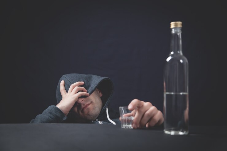 Alkoholik z kieliszkiem wódki