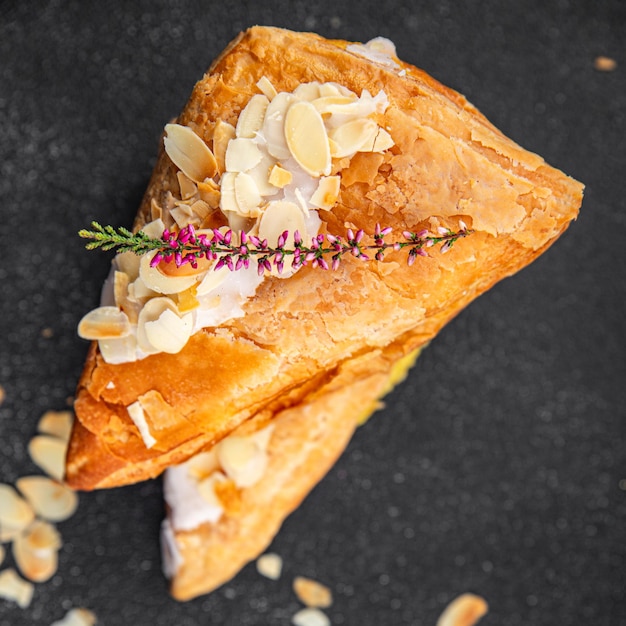 almond triangle cake cream puff pastry sweet dessert delicious healthy eating cooking appetizer meal food snack on the table copy space food background rustic top view