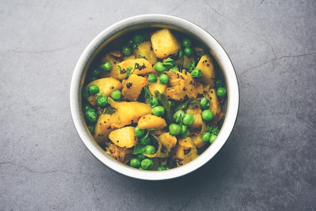 Aloo Mutter lub Matar aalu suche sabzi, indyjskie ziemniaki i zielony groszek smażone razem z przyprawami i przybrane liśćmi kolendry. podawane z roti lub chapati