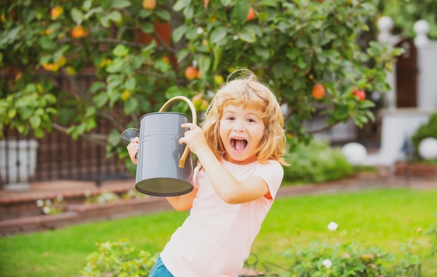 Amerykańskie dzieci na farmie Słodkie dzieciństwo Szczęśliwe dziecko na letnim polu Podlewanie w ogrodzie