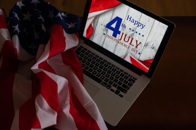 Amerykańskie flagi z napisem Happy Independence Day na laptopie