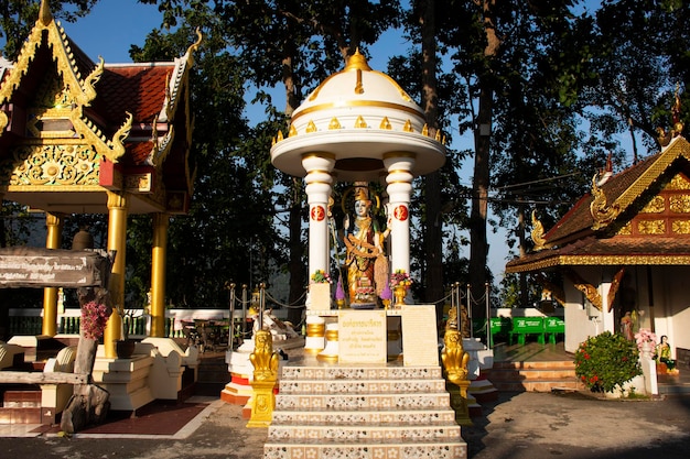 Anioł bóstwa i posąg Buddy świątyni Wat Phra That Doi Kham dla Tajów i zagranicznych podróżników podróżująca i szanująca modlitwa w mieście Mae Hia 10 listopada 2020 r. w Chiang Mai Tajlandia