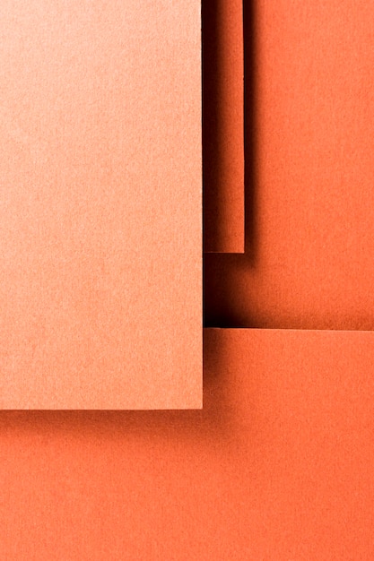 Zdjęcie asortyment monochromatycznych martwych natur z pomarańczowym papierem