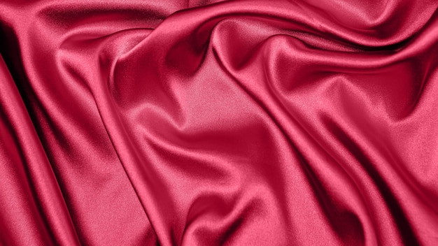 Atlas tkaninowy Viva Meganta w stonowanej czerwieni. Bliska różowa jedwabna satynowa tekstura do szycia