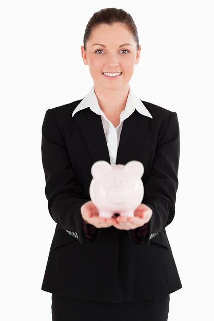 Atrakcyjna kobieta trzyma różowego prosiątko banka w kostiumu