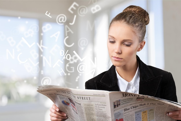 Zdjęcie atrakcyjna młoda kobieta czyta gazetę