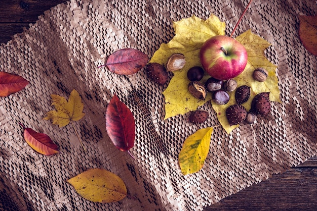 Autumn still life concept background Autumn leaves harvest goodies on table top Thanksgiving postcard