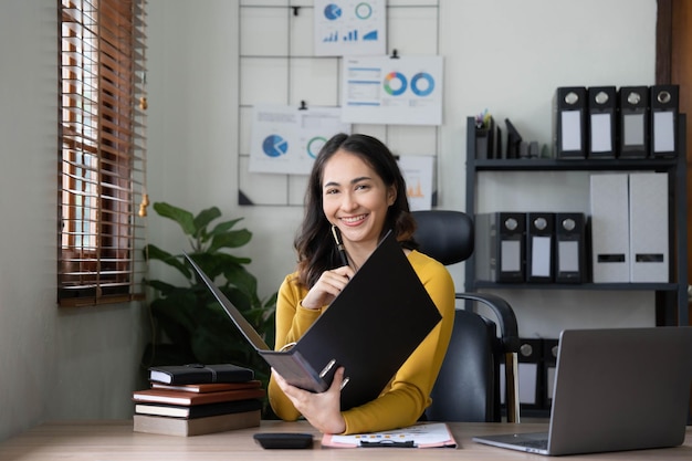 Azjatycka bizneswoman spotyka się w biurze robiąc notatki i używając tabletu w biurze