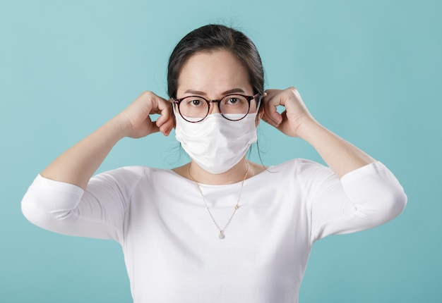 Azjatycka młoda kobieta jest ubranym maskę oddechową