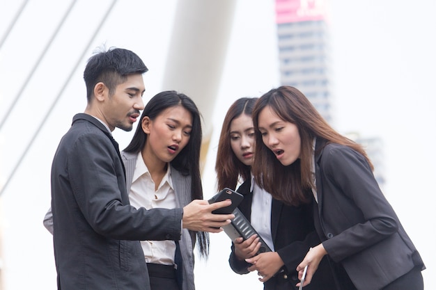 Zdjęcie azjatycki biznes drużyna patrząc na smartphone.