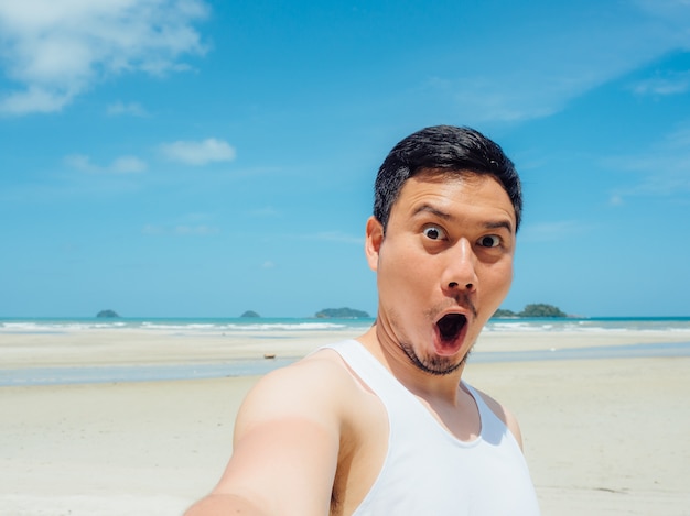 Azjatycki mężczyzna na słonecznej lato plaży wycieczce.