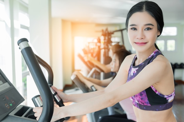 azjatycki sport kobieta cieszyć się treningu z bieżnią w siłowni centrum fitness z grupą ludzi