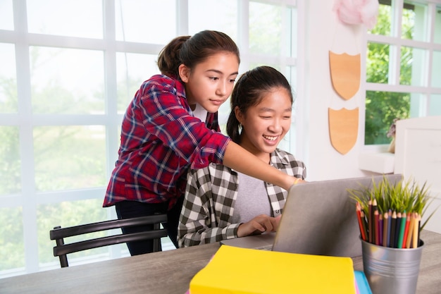 Azjatyckie Nastolatek Studentów Dziewcząt Studiujących Oglądanie Komputera W Domu