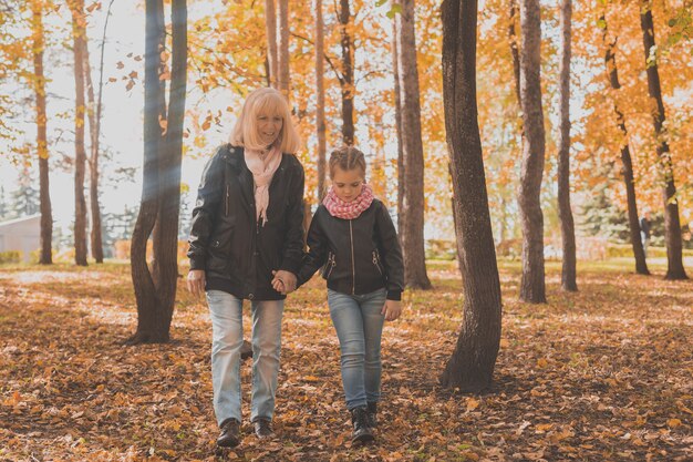 Babcia z wnuczką w jesiennym pokoleniu parku i koncepcji rodziny