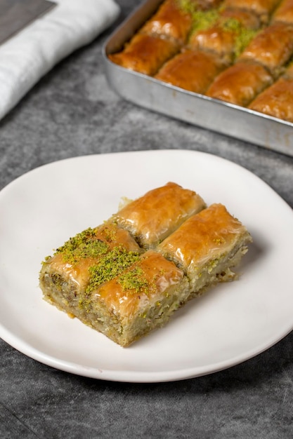 Baklava z pistacją na ciemnym tle Tradycyjna turecka baklava na talerzu