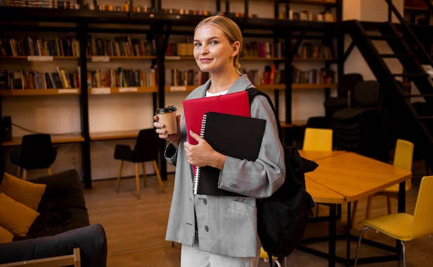 Zdjęcie bardzo młoda kobieta pozuje w bibliotece