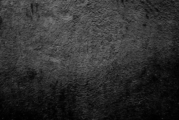 Bezszwowa tekstura czarnej cementowej ściany o szorstkiej powierzchni gradientowej czerni