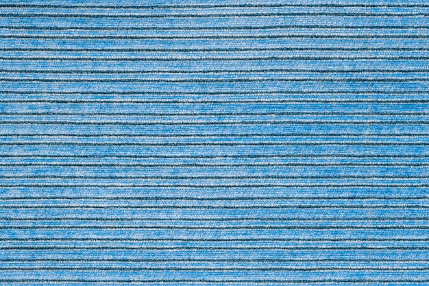 Bezszwowa tekstura poziomej, prążkowanej niebieskiej tapicerki poliestrowej