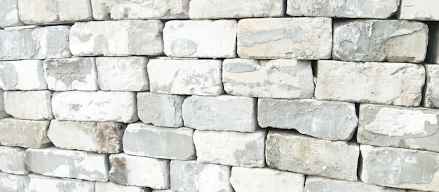 Zdjęcie biała kamienna ściana z szarym kamiennym tłem