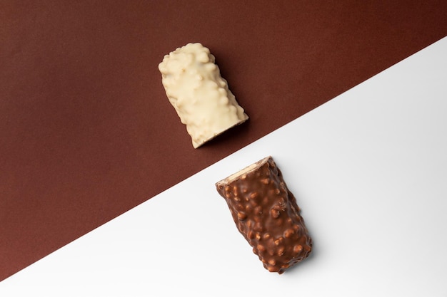 Białe i brązowe tabliczki czekolady na kontrastowym tle widok z góry