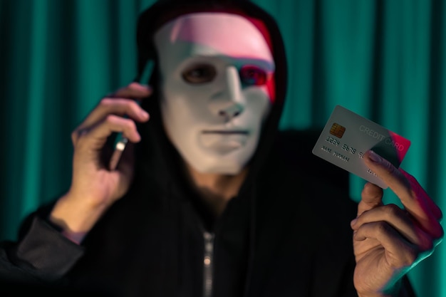 Biały przestępca w masce dzwoni do właściciela karty kredytowej, by zagrozić okupem.