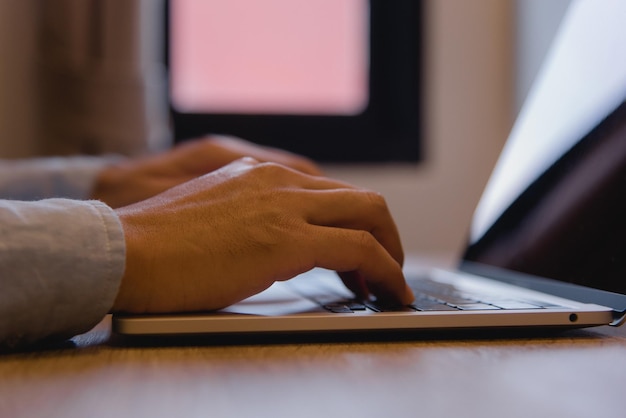 Biznesmen pracujący laptop komputer ręcznie wpisując klawiaturę komputer technologia biurowa komunikacja internet na biurku