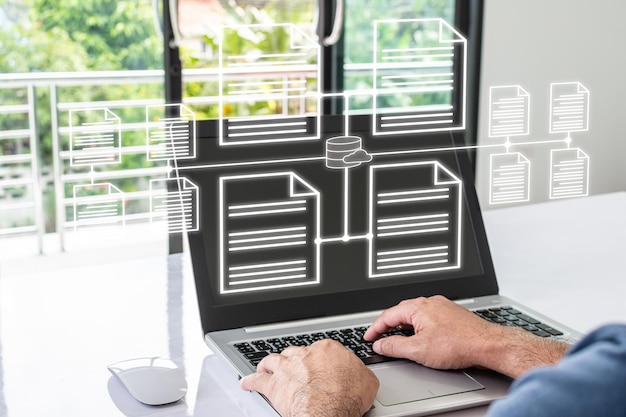 Zdjęcie biznesmen pracuje z domu za pomocą laptopa z wirtualnym ekranem przetwarza dane i efektywnie zarządza plikami w internecie system bazy danych dokumentów online i koncepcja elektronicznego systemu zarządzania dokumentami