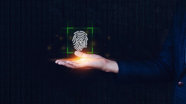 Biznesmen używający pokazywania skanującego odcisku palca Tożsamość biometryczna i autoryzacja futurystyczna koncepcja bezpieczeństwa hasła i kontroli poprzez odcisk palca w przyszłości