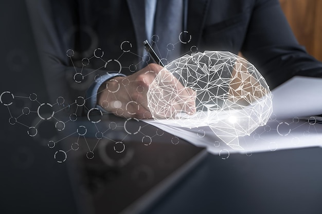 Zdjęcie biznesmen w garniturze podpisuje umowę podwójna ekspozycja z hologramem mózgu nowe partnerstwo w koncepcji biznesowej