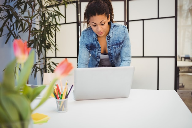 Bizneswoman używa laptop przy biurkiem