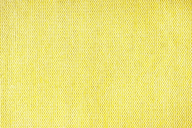 Bliska tekstura żółtego grubego splotu tkaniny obiciowej Dekoracyjne tło tekstylne