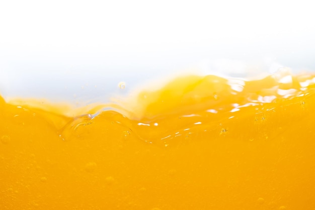 Blisko jasny sok pomarańczowy strumień tekstury dla zdrowia i natury fale Piękne fale krzywe i małe pęcherzyki gładkie dla garficznego projektu i tła