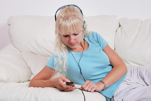 Blondynka słuchająca swojego odtwarzacza mp3