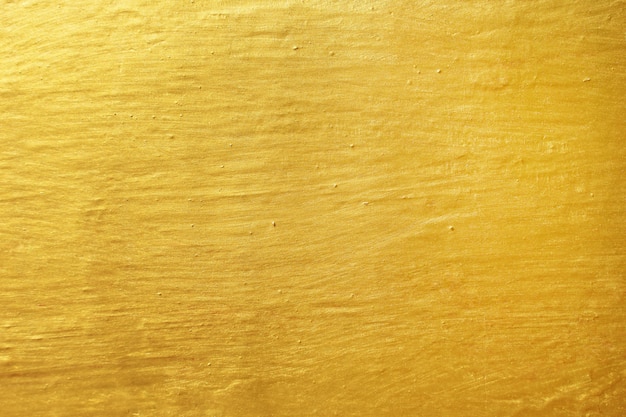 Błyszczący żółty liść złocistej folii tekstury tło
