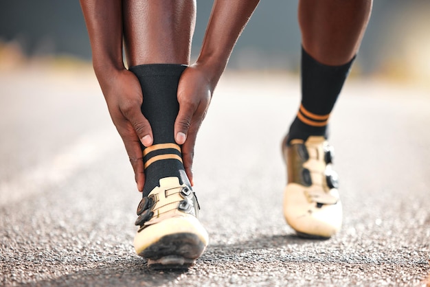 Ból stopy i człowiek na drodze do ćwiczeń cardio lub ćwiczeń w nagłych przypadkach medycznych w mieście Nogi stóp i biegacz trenujący sport na drodze z kontuzją podczas treningu lub biegu