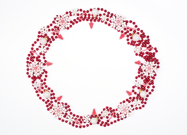 Boże Narodzenie lub zima białe tło z okręgiem utworzonym z czerwonych koralików i ozdób świątecznych Makieta karty z pozdrowieniami Koncepcja wakacji nowego roku Płaski styl z miejsca na kopię