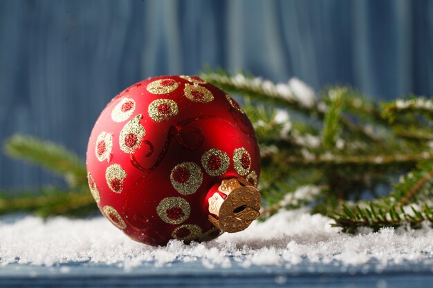 Bożenarodzeniowa dekoraci piłka na śnieżnym drzewie na błękita stole