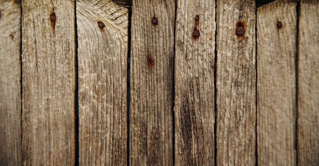 Brązowa lub szara struktura drewna. Abstrakcyjne tło. rustykalne tło starych drewnianych desek z otworami i gwoździami.