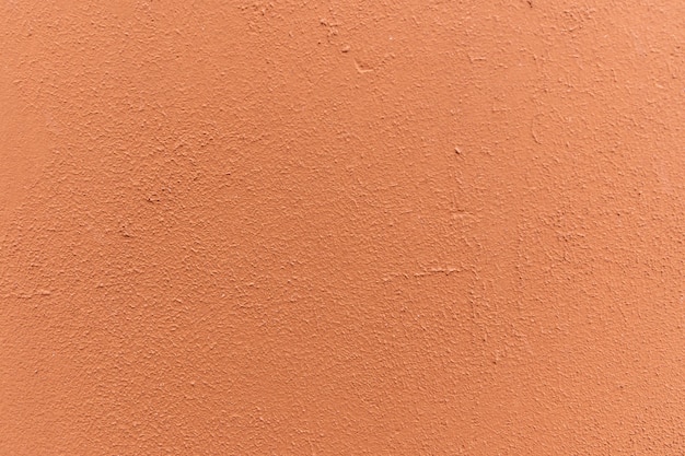Brązowo-pomarańczowa ściana, tynk. Solidna przestrzeń tekstur