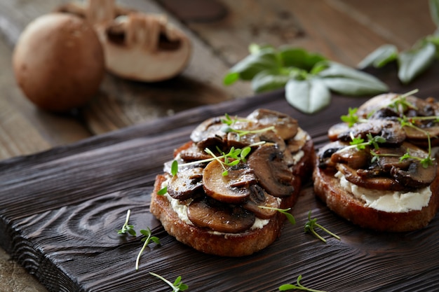 Bruschetta Z Pieczarkami I Kremowym Serem Na Drewnianym Nieociosanym Tle