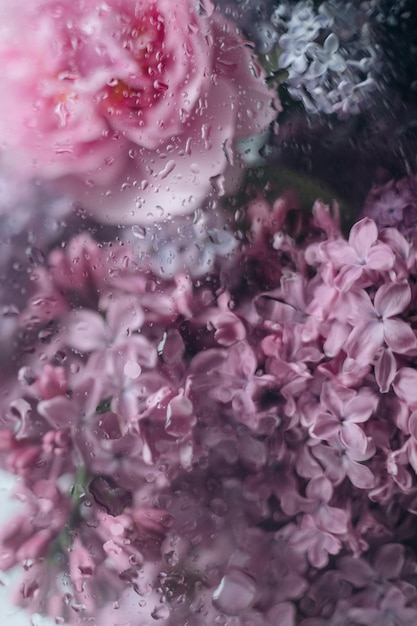 Bukiet kwiatów z kroplami deszczu na szkle