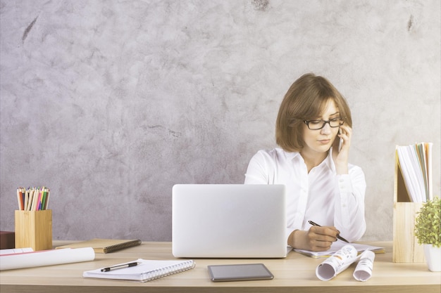 Businesswoman na telefonie robi papierkową robotę