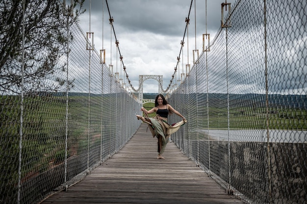 Zdjęcie cała długość kobiety tańczącej na mostku