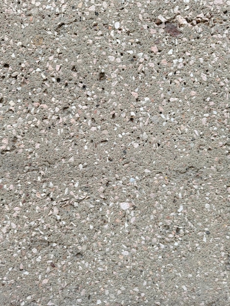 Cementowa ściana z kamienną teksturą przeplatająca się kamiennymi szczelinami